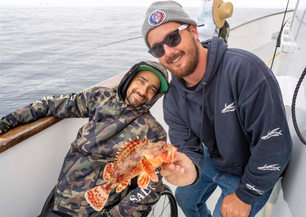 TACO Marine Life Rolls On Jesse Billauer with fish.